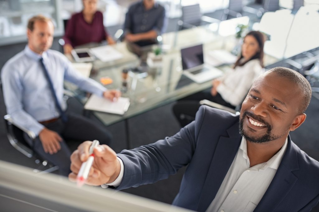 bigstock Black businessman writing on a 353046860