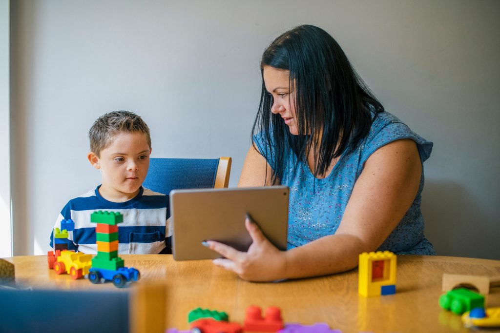 bigstock Mother teaching son from a tab 270719785